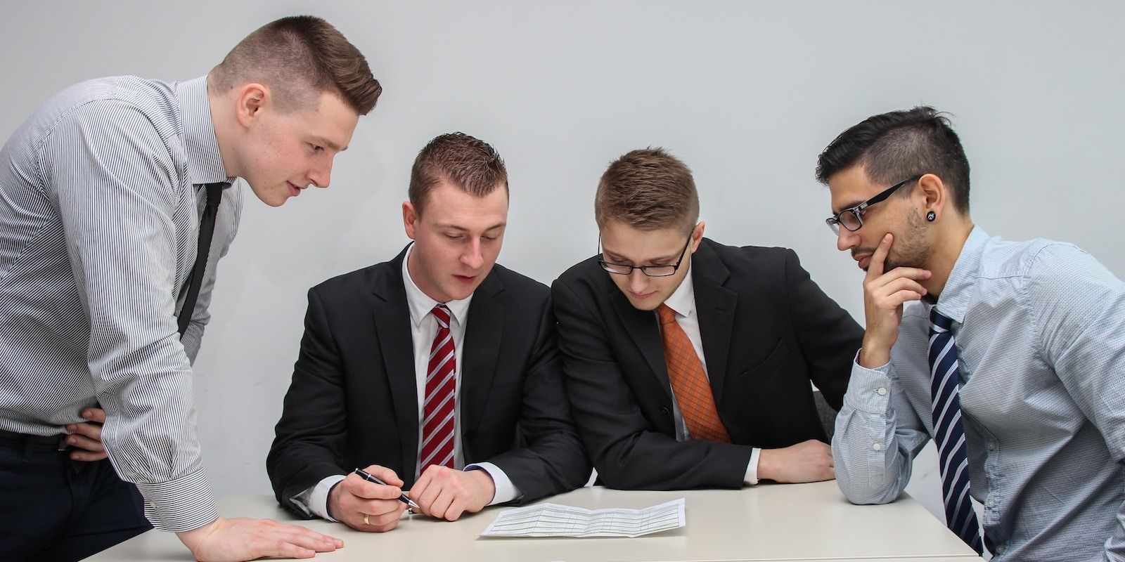 A Group of Businessmen in Suits Discussing Projects