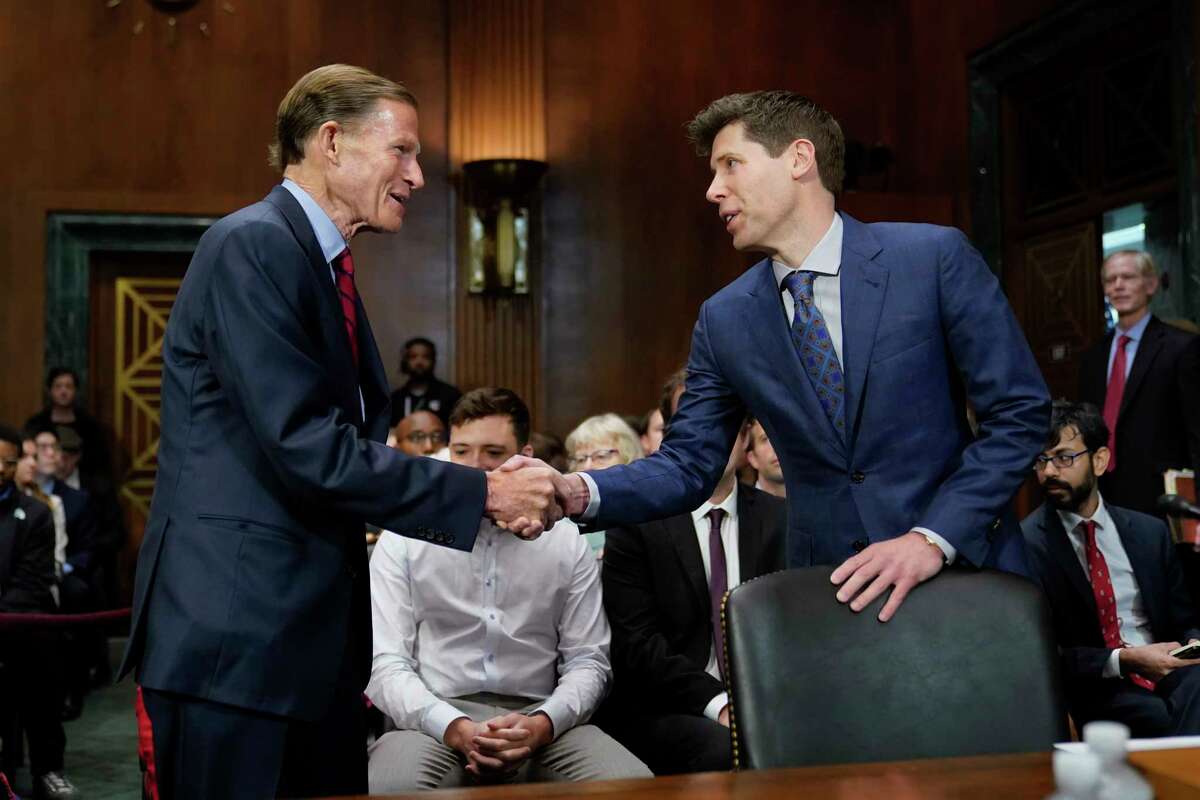 Sen. Richard Blumenthal, D-Conn., left, chair of the Senate Judiciary Subcommittee on Privacy, Technology and the Law, greets OpenAI CEO Sam Altman before a hearing on artificial intelligence, Tuesday, May 16, 2023, on Capitol Hill in Washington.